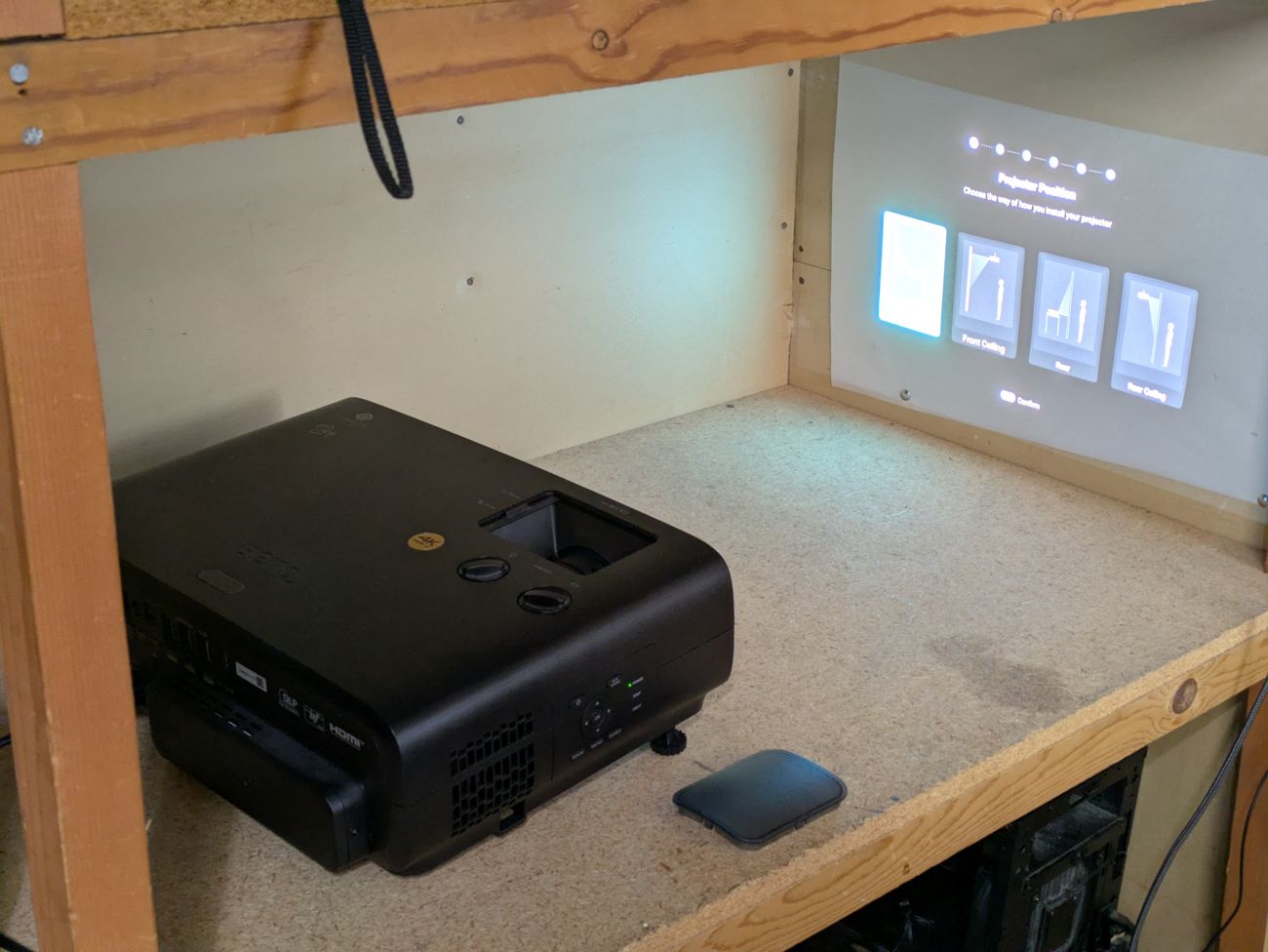 BenQ W4100i powered on and projecting onto the test wall