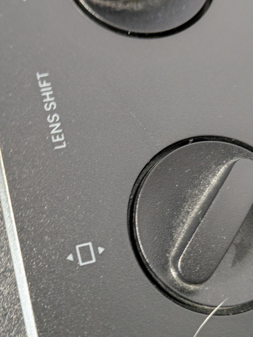 Macro of the lens-shift dial under raking light